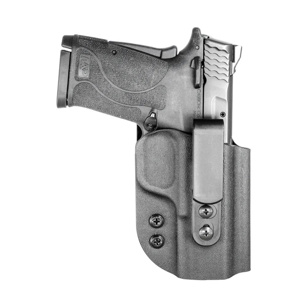 Compact handgun in black holster with belt clip
