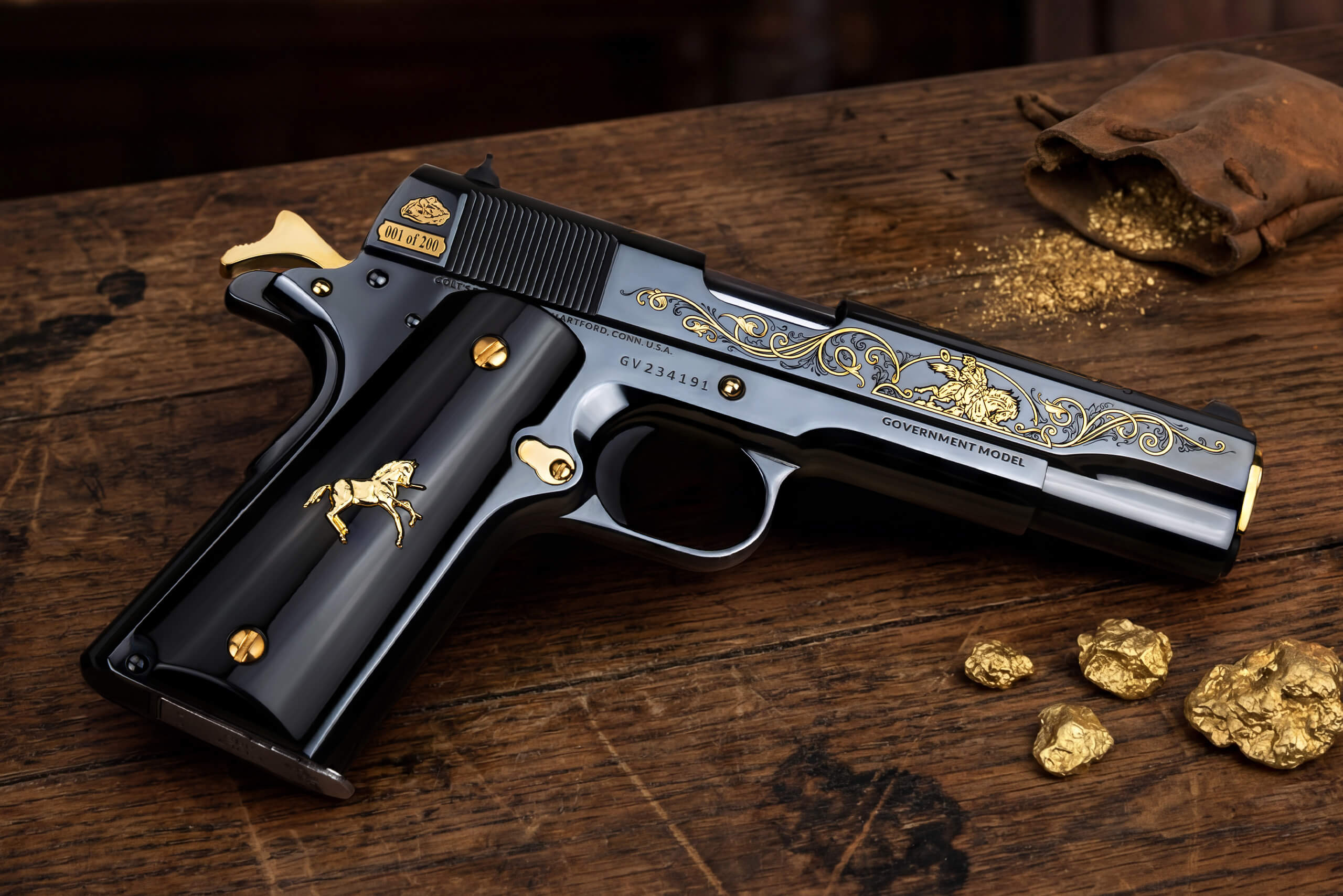 Ornate gold-engraved pistol on wooden table