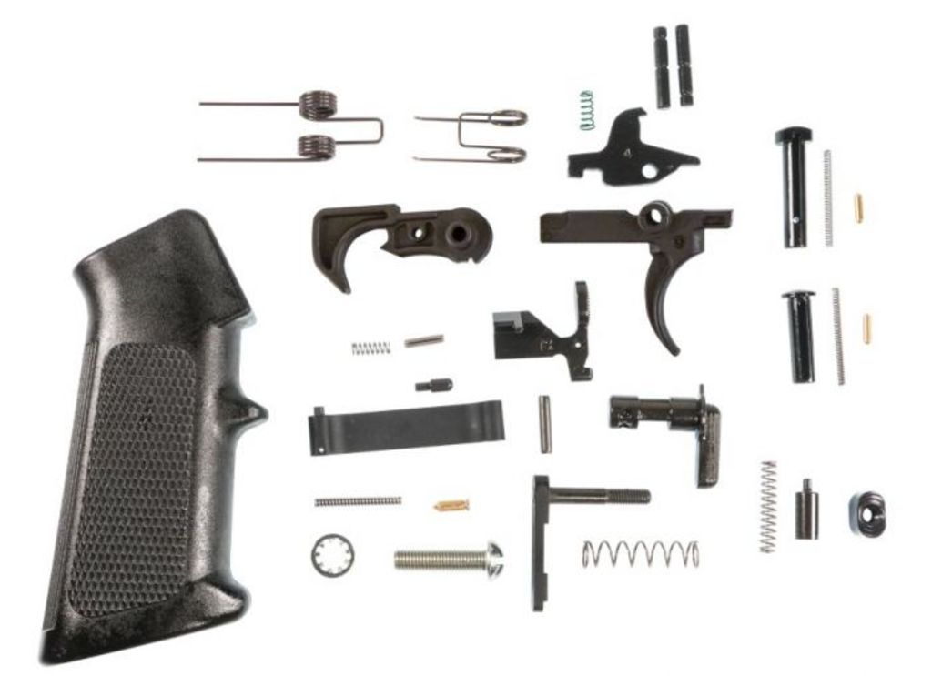 Disassembled firearm trigger components and pistol grip