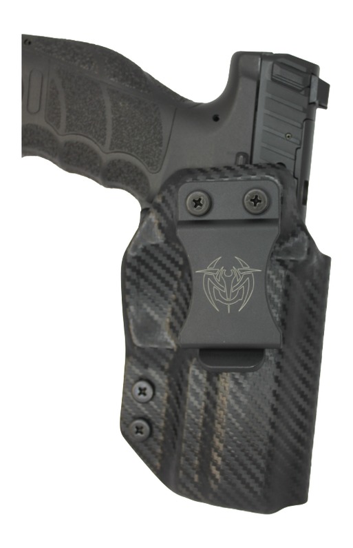 Handgun in carbon fiber holster with belt clip