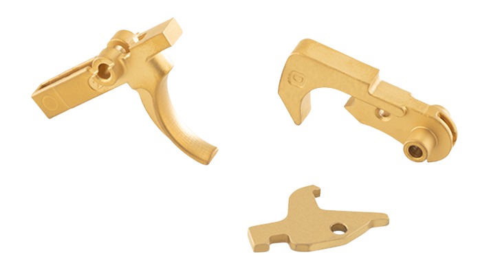 Gold-colored metal mechanical components on white background