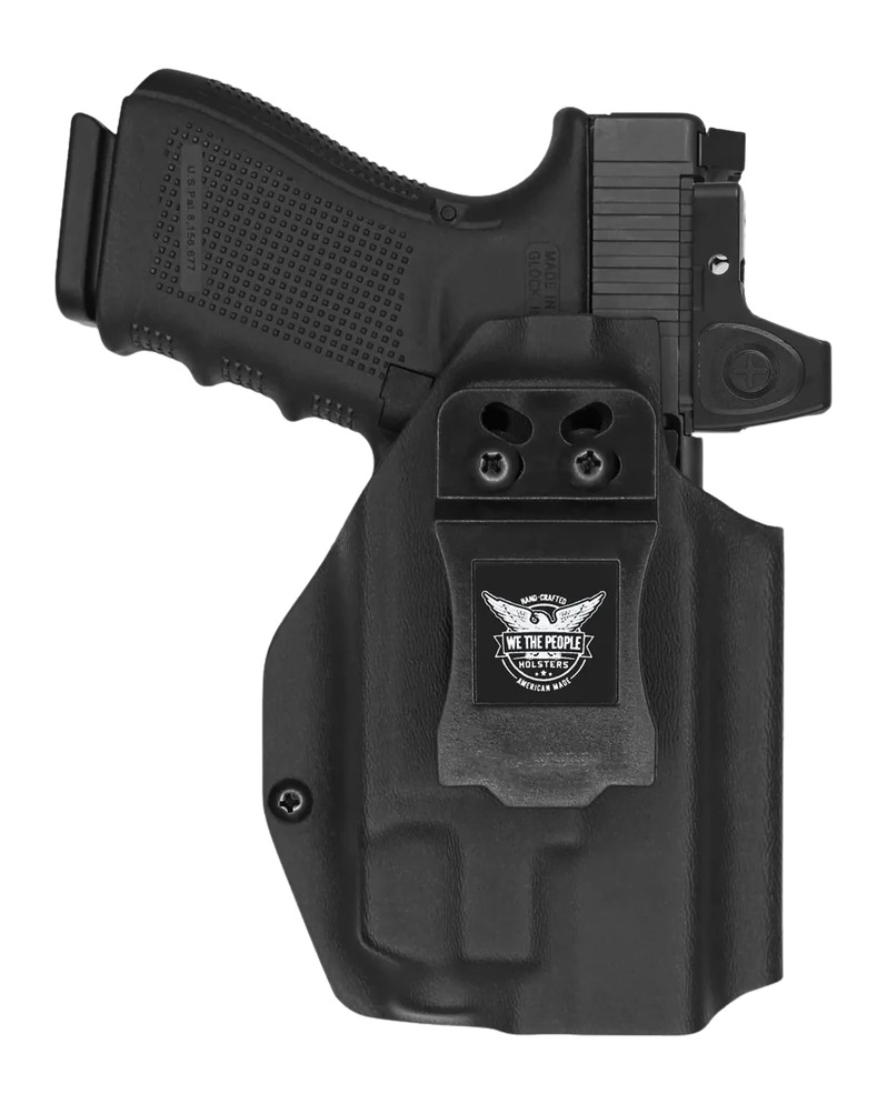 Black handgun in polymer holster with clip