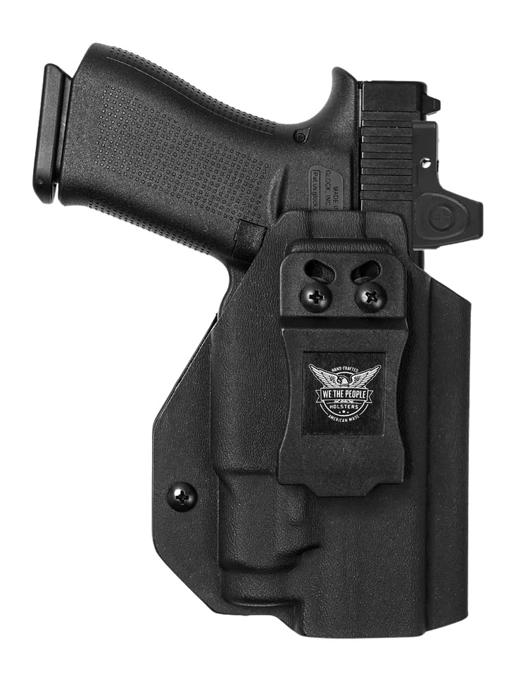 Black handgun in Kydex holster with belt clip