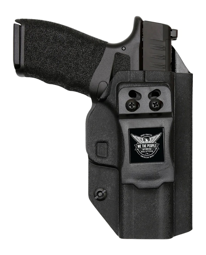 Black handgun in molded polymer holster