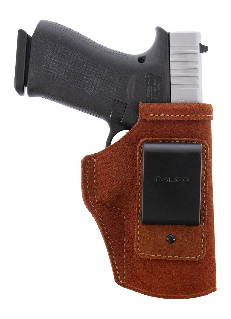 Handgun in brown leather holster with belt clip