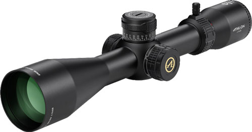 Black rifle scope with adjustment turrets and green lens
