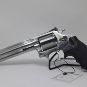 Silver revolver with black grip on white background