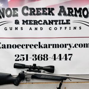 Rifle displayed beneath Canoe Creek Armory sign