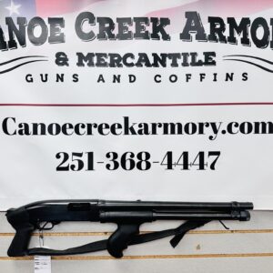 Shotgun displayed beneath Canoe Creek Armory sign