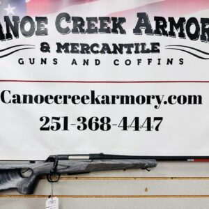Rifle displayed beneath Canoe Creek Armory sign