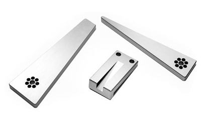 Three machined metal components on white background