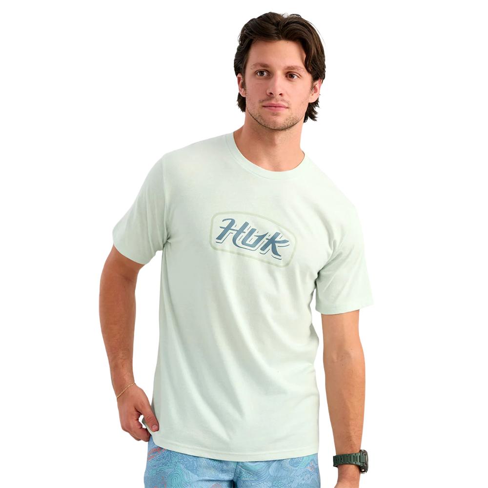 Man wearing light green Huk logo T-shirt