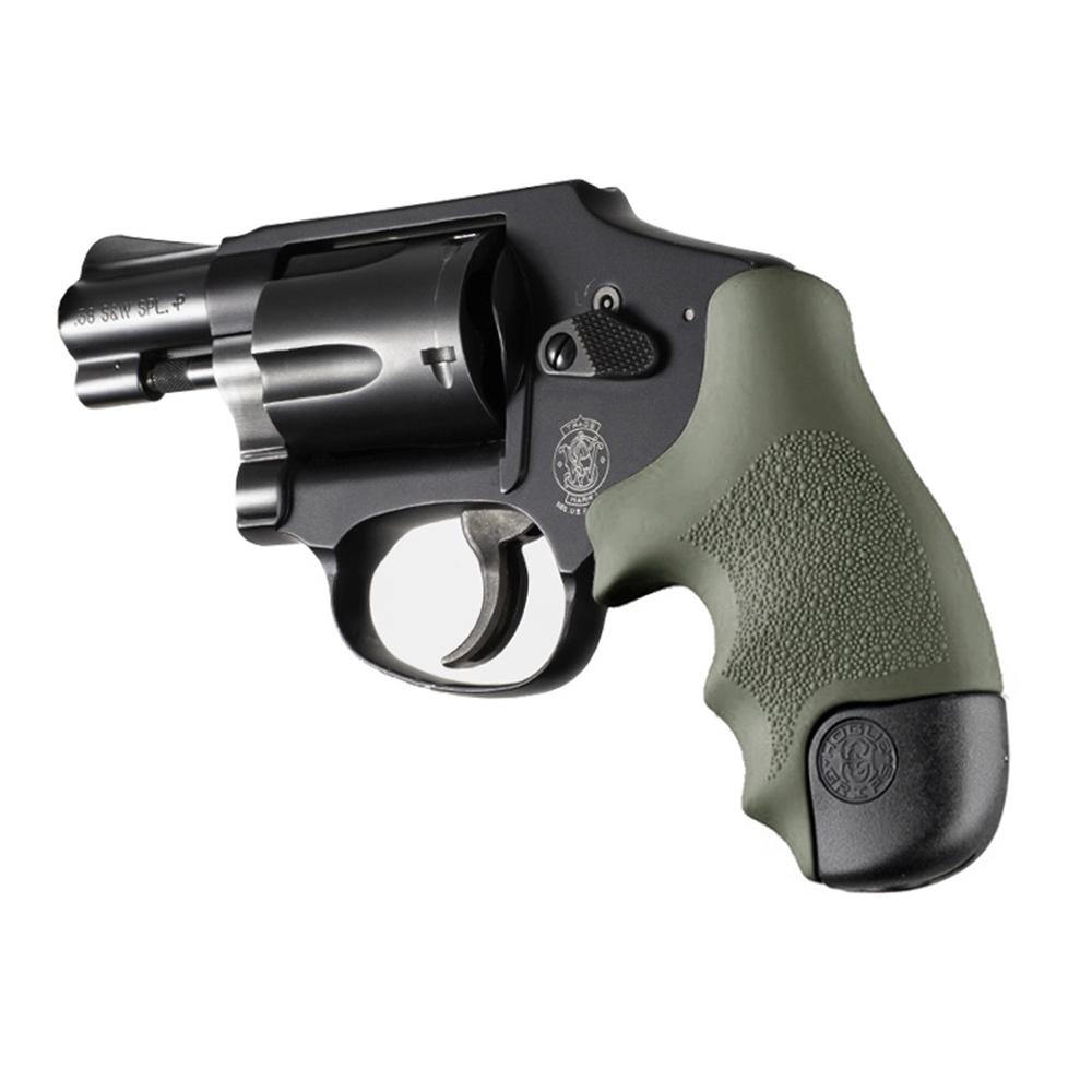 Compact black revolver with green textured grip