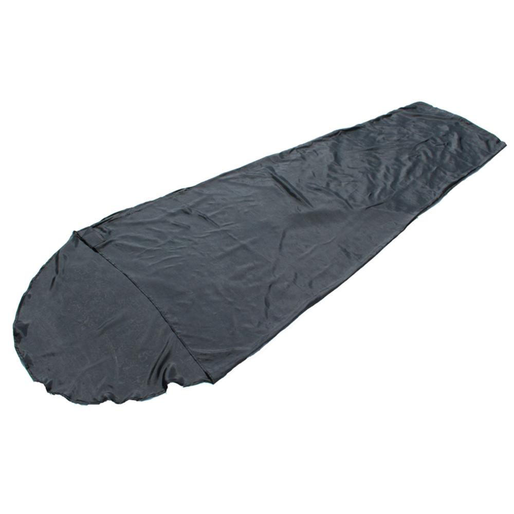 Black sleeping bag laid flat on white background