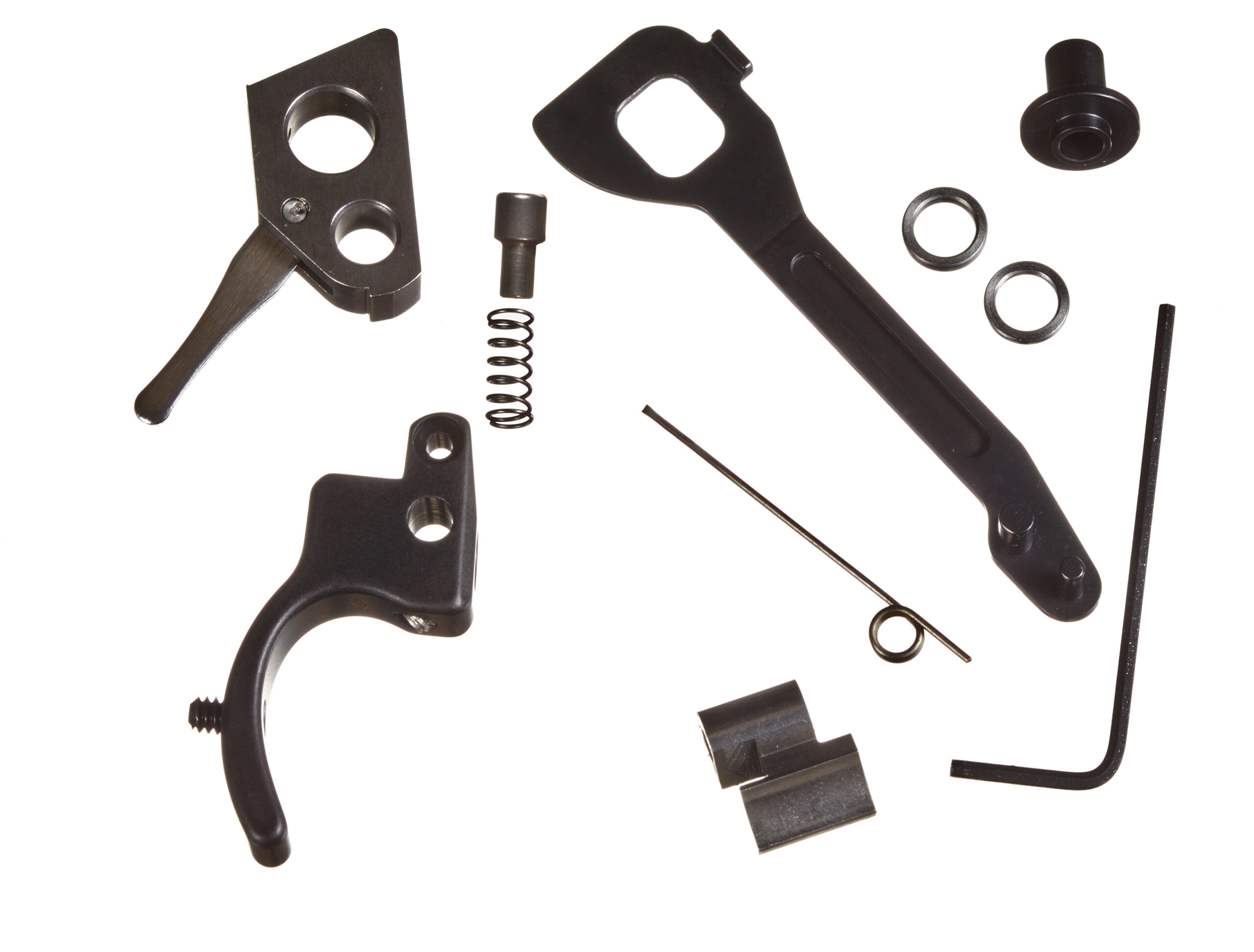 Disassembled firearm trigger assembly components on white background