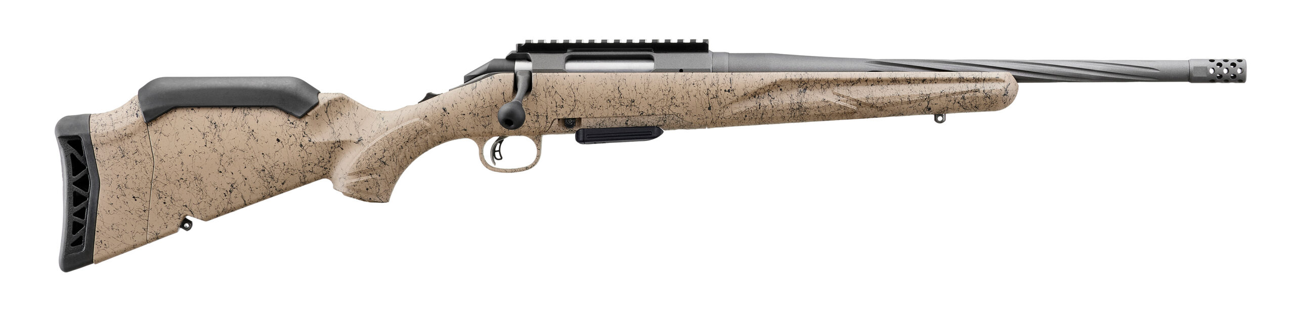 Bolt-action rifle with tan speckled stock and muzzle brake