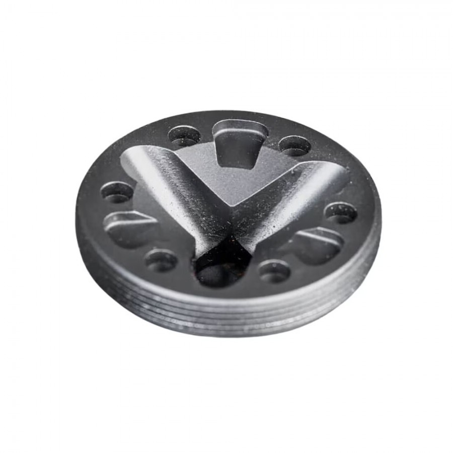 Black circular metal mechanical component with raised V-shaped channels