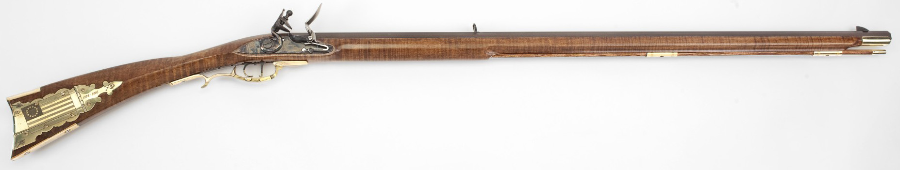 Ornate flintlock rifle with American flag brass inlay