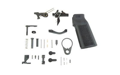 Disassembled firearm trigger components and black pistol grip